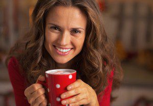 A pretty woman holding a red cup